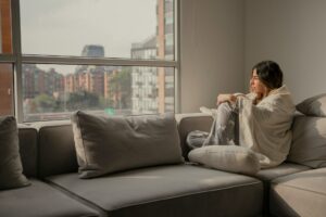 woman at home with blanket wrapped around her
